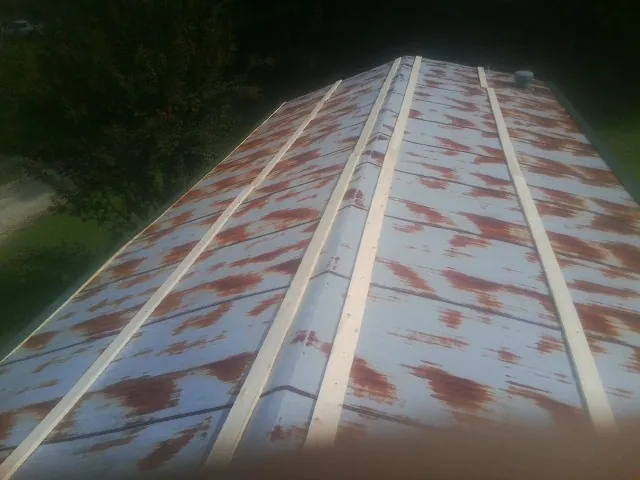 Rusted metal roof panels with new wood purlins before replacement — Storm Damage Roof Repair in Gorham by Roofing Brothers